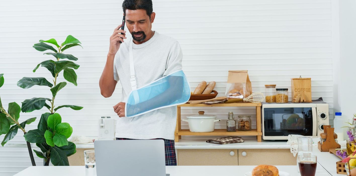 Man at home with injured arm