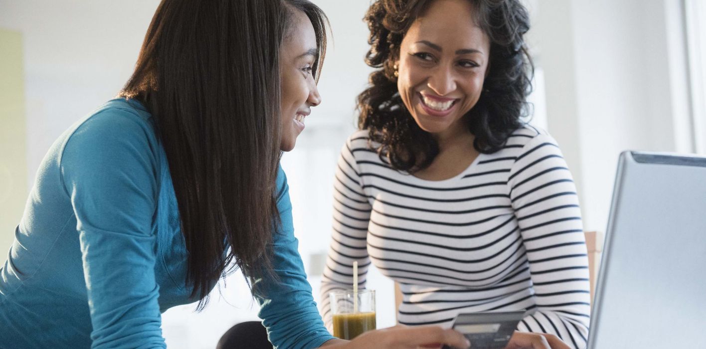 Mother teaching daughter about credit 