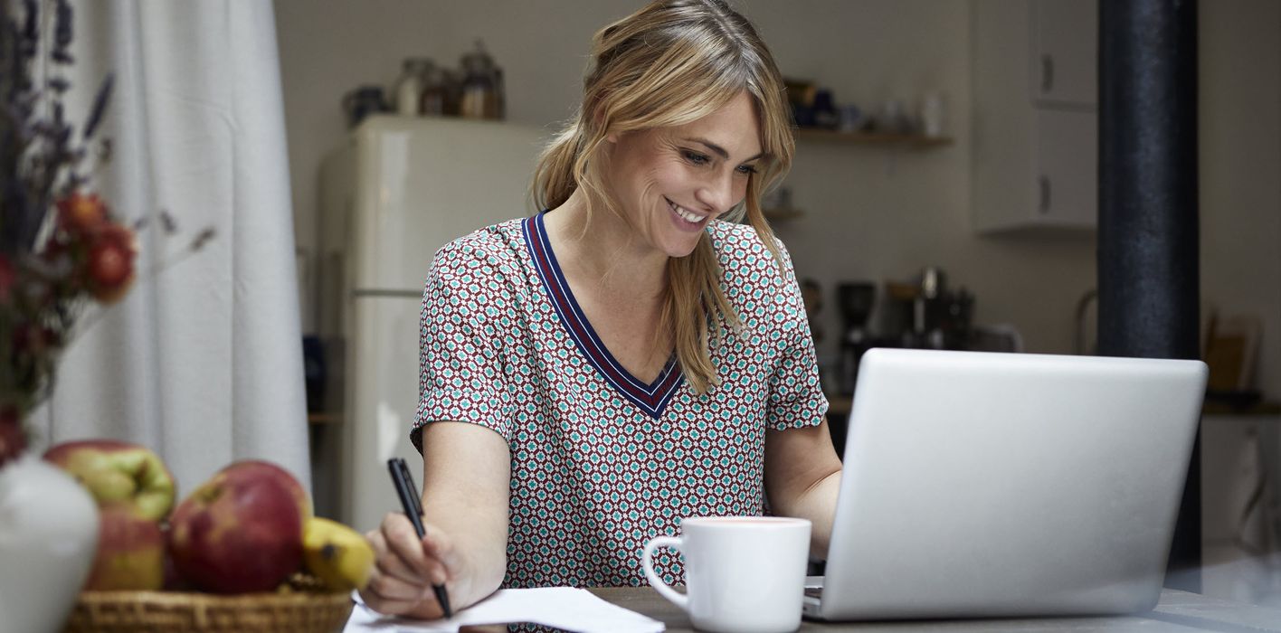 Woman looking at a laptop trying to determine what to do with a windfall