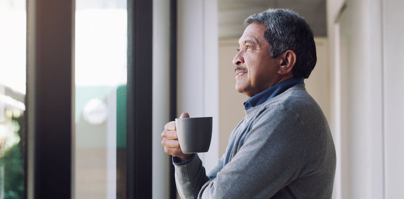 Man drinking a cup of coffee while noodling on the economic insights shared in this edition of Northwestern Mutual’s weekly market commentary.