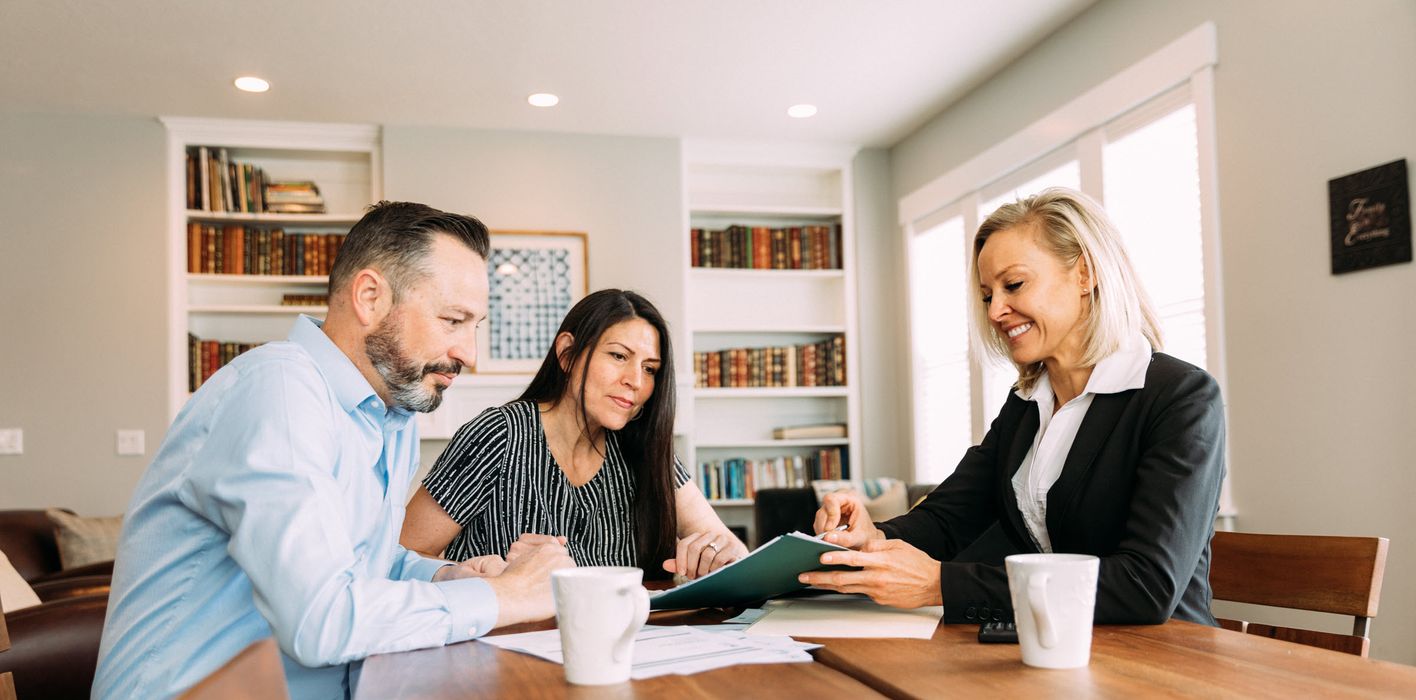 Couple meeting with a financial advisor and discussing sequence of returns risk.