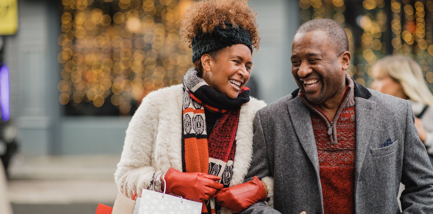 Happy couple enjoying winter holiday shopping thanks to their solid financial plan with a Northwestern Mutual advisor.
