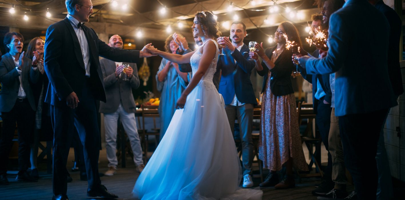 A couple dances in a wedding tent 