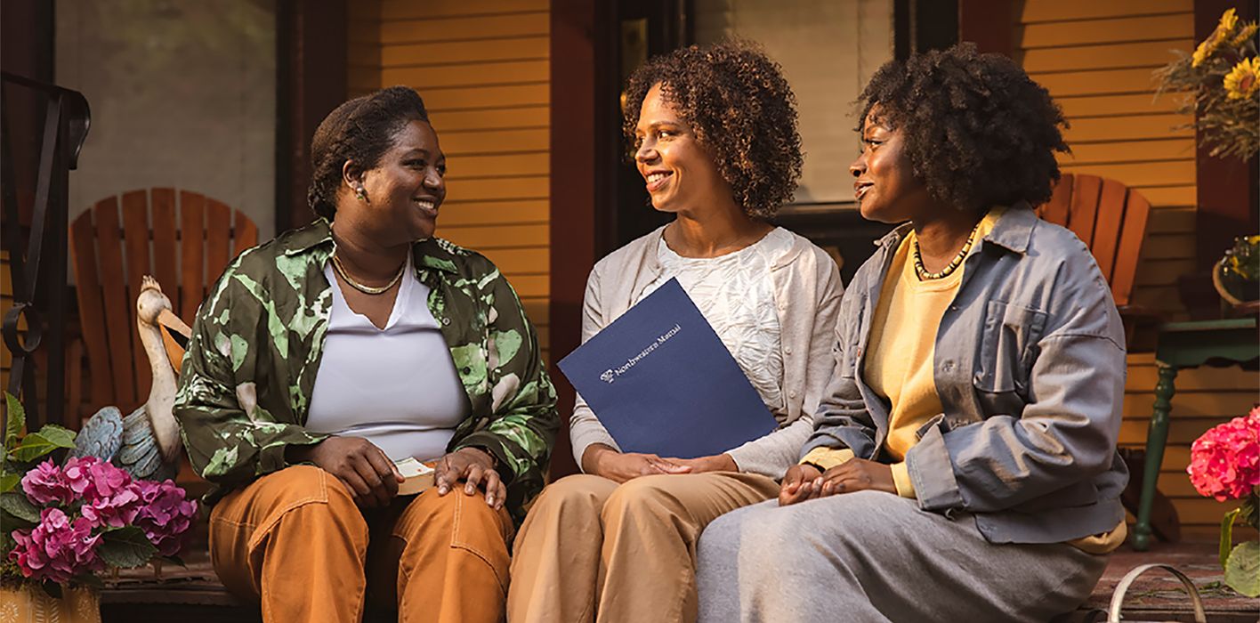 women talking on a porch