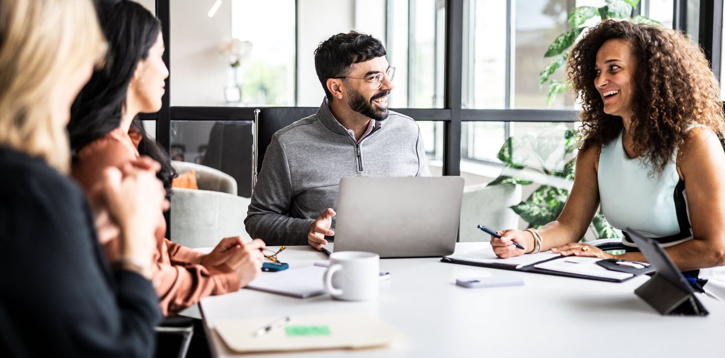 Coworkers meet and strategize over the state of the economy and markets, empowered by a solid financial plan with Northwestern Mutual Wealth Management Company