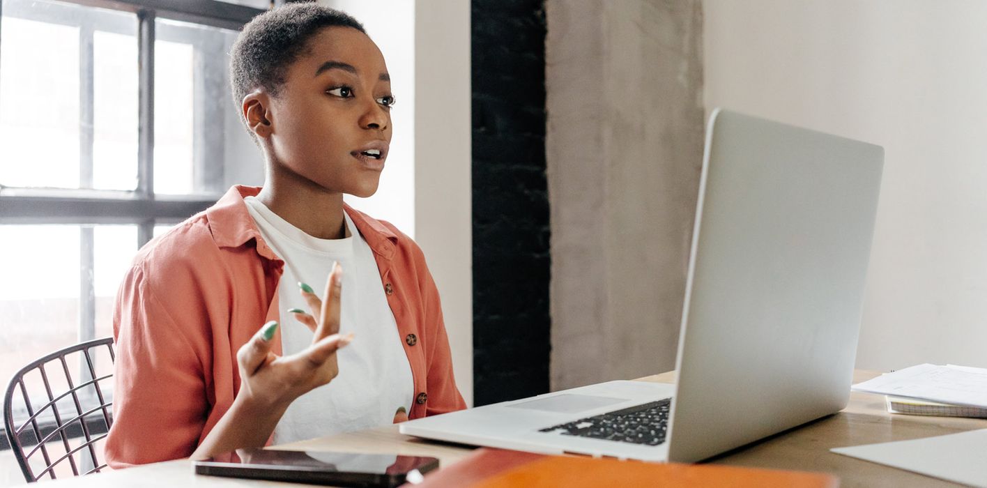 A woman in a modern office reading Northwestern Mutual Wealth Management Company Weekly Market Commentary and analyzing the economic fallout of the Iran war and the blockade of the Strait of Hormuz, which has triggered a spike in global inflation and stalled Federal Reserve rate cuts.