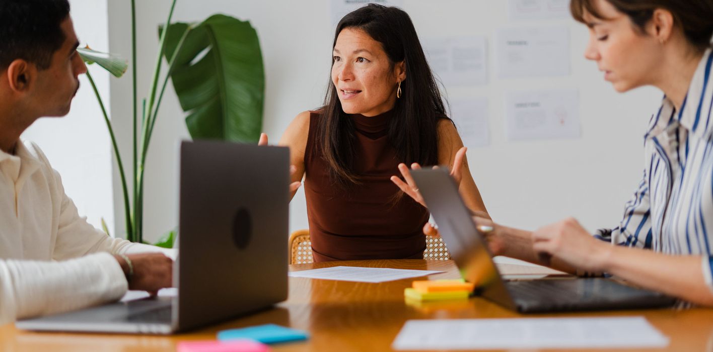 Financial professionals conduct team meeting in sunlit office