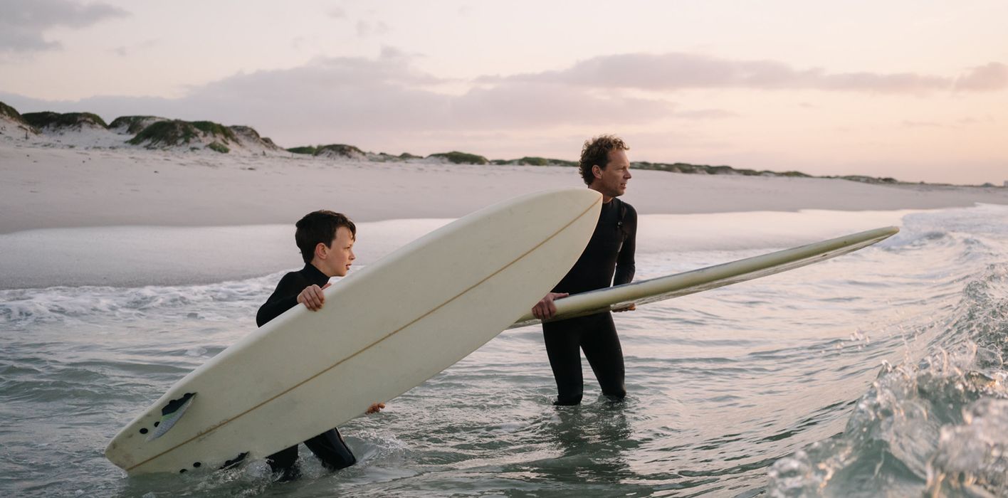 Father and son enjoy surfing trip while celebrating financial freedom and a solid plan with Northwestern Mutual