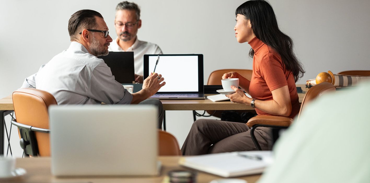 Business Meeting Among Colleagues With Laptops and Coffee