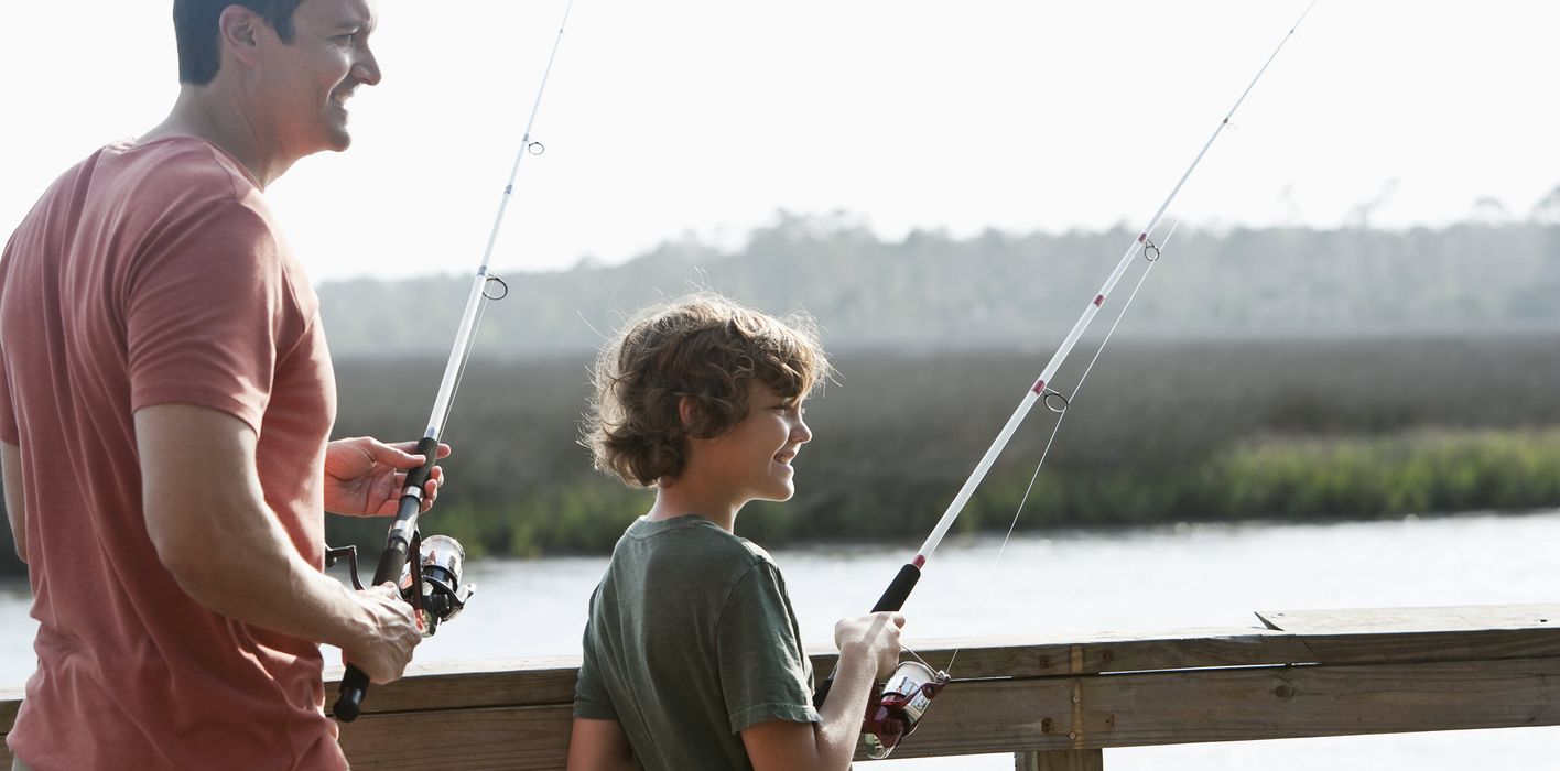 Dad fishing with son and wondering how tariffs will affect the economy.
