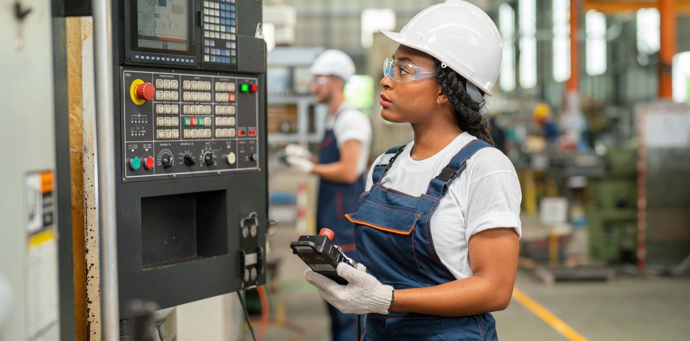 Woman working in a factory wondering how tariffs will impact her job and the economy.