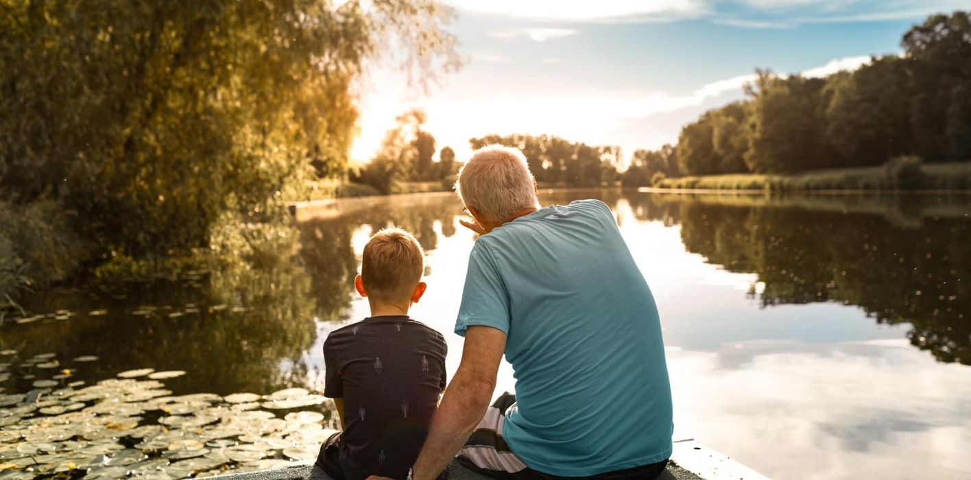 grandfather and grandson on the water