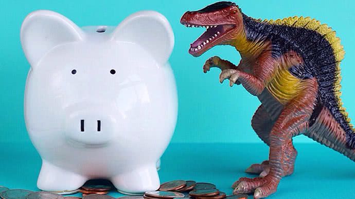 Piggy bank and toy dinosaur.