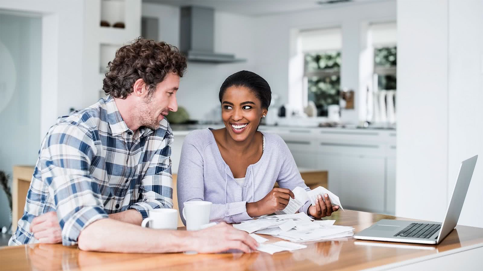 Couple at a table discussing the financial steps to take before applying for a mortgage