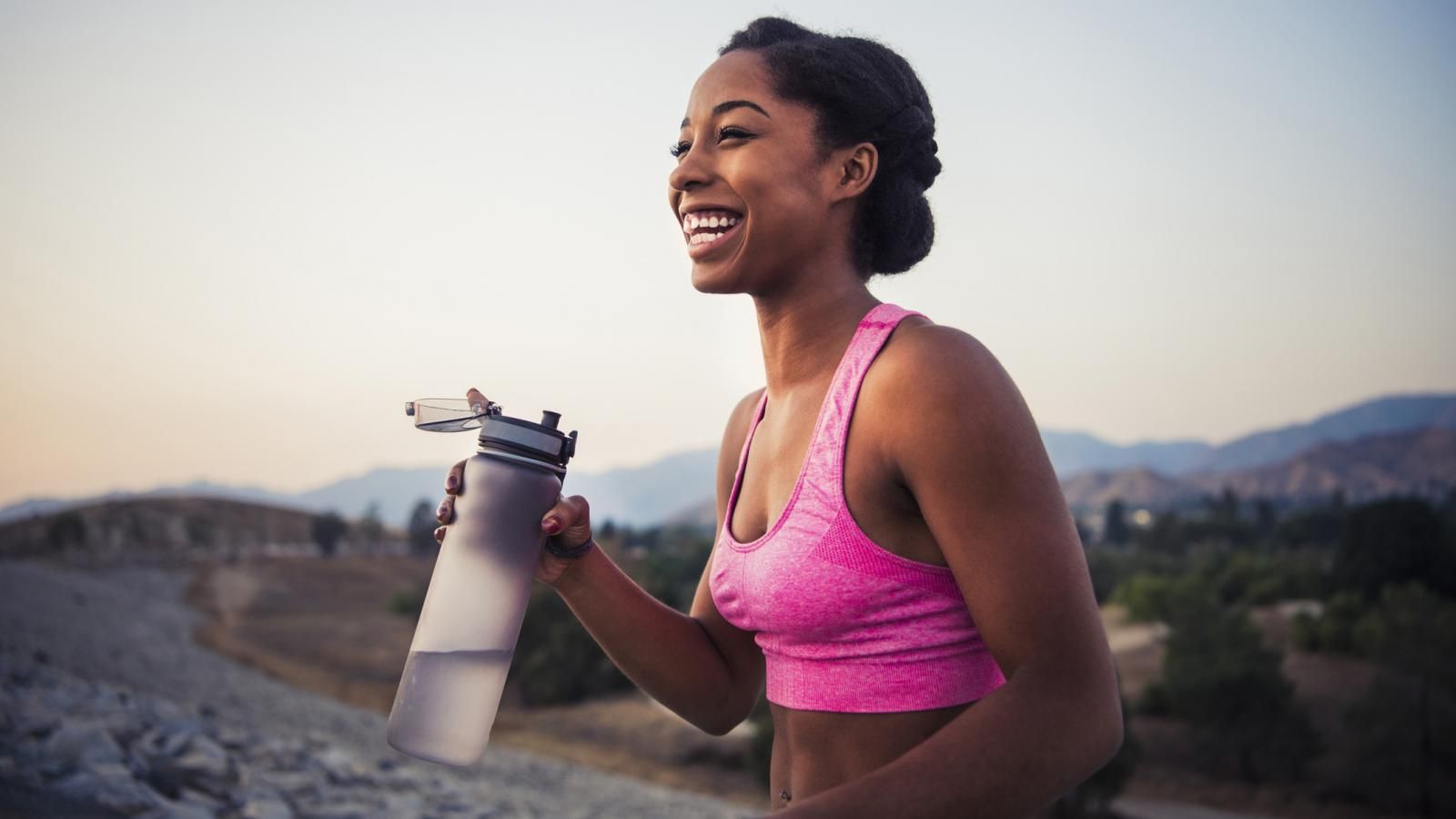 woman with water bottle pursuing wellness goals