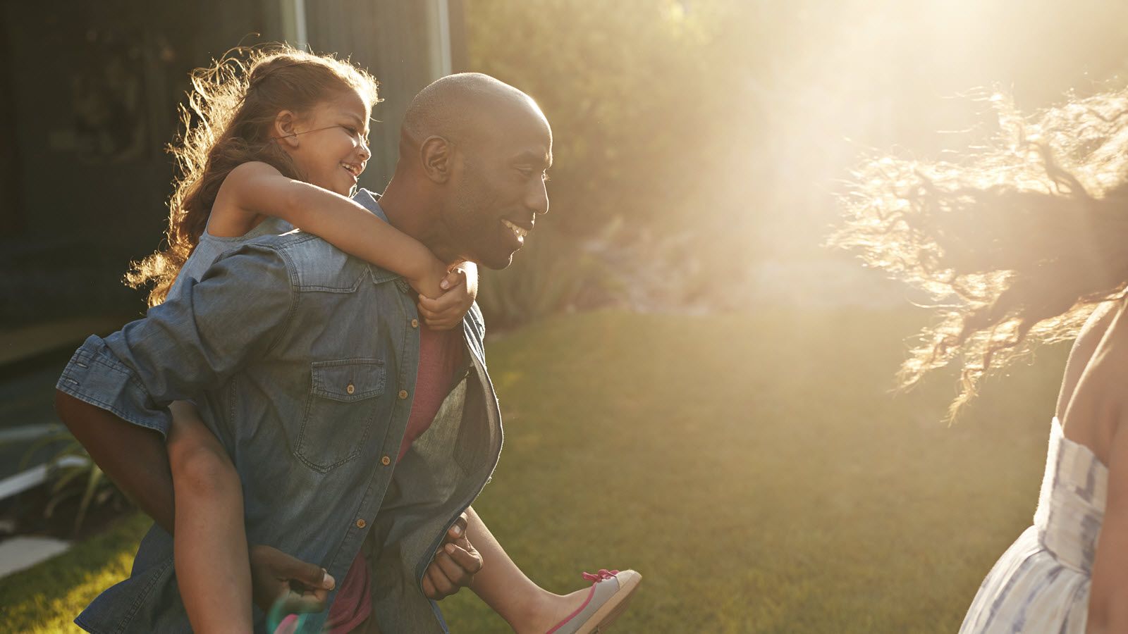 Man playing with kids in backyard wondering how much life insurance he needs.