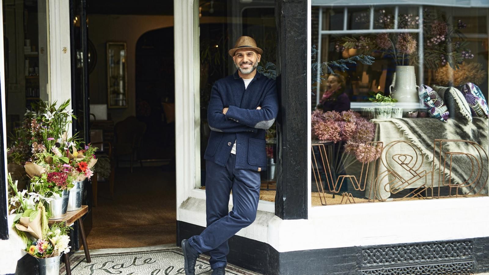Man standing int front of his furniture store.