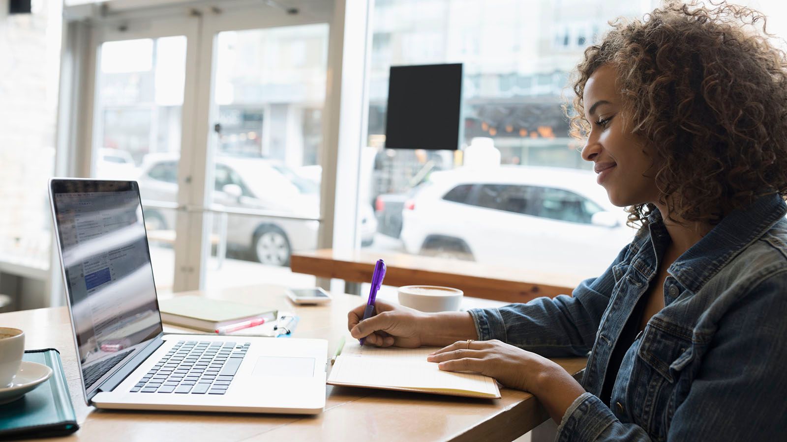 self-employed woman working on laptop researching benefits