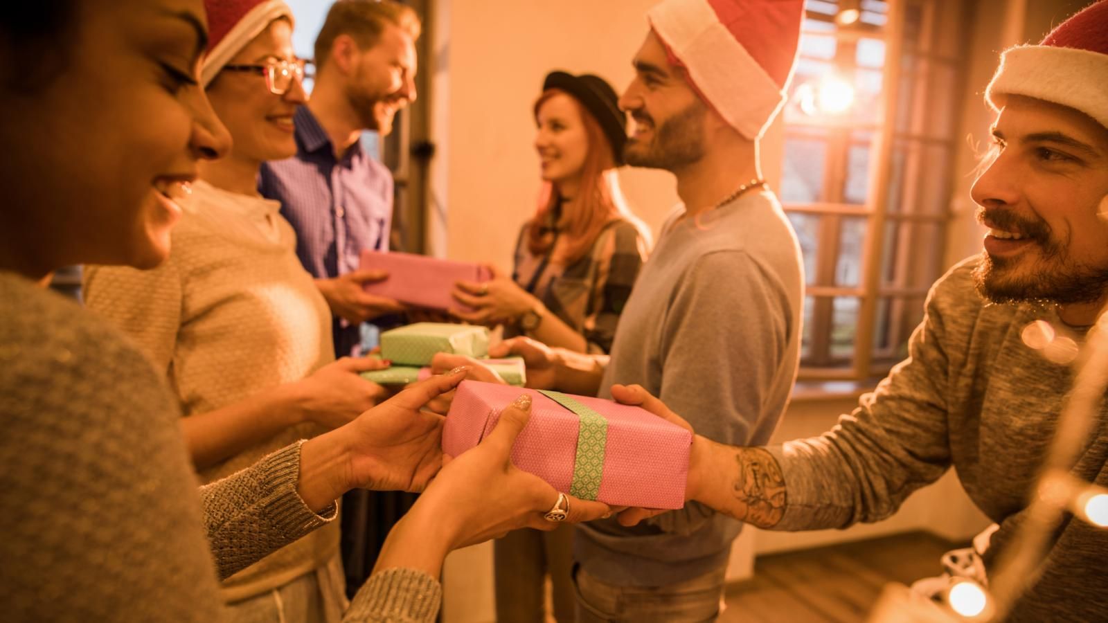 Colleagues exchanging gifts during holiday office party