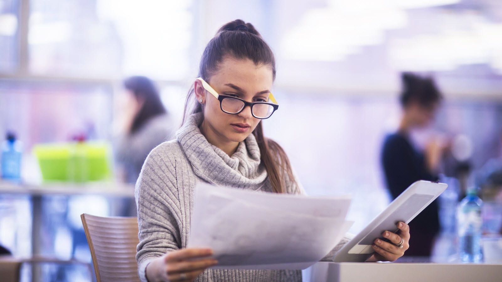Woman looking at papers trying to determine the difference between an FSA vs. an HSA.