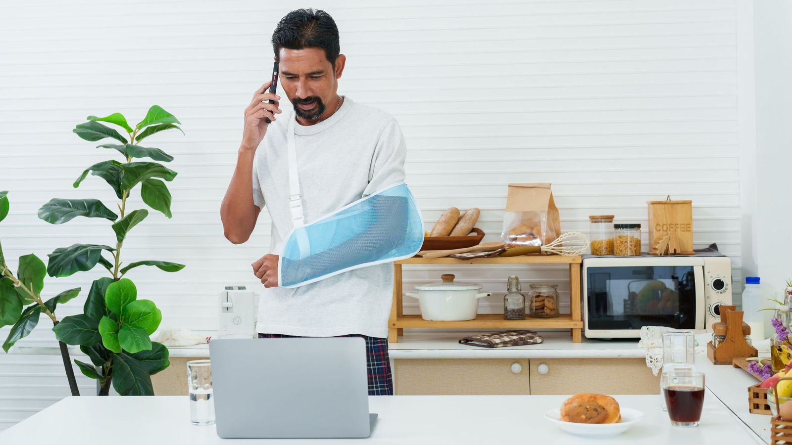 Man at home with injured arm