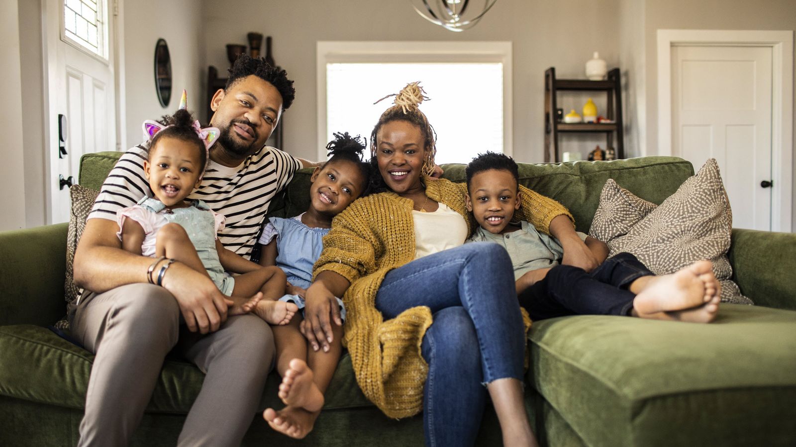 Family on a couch talking about cash value life insurance.