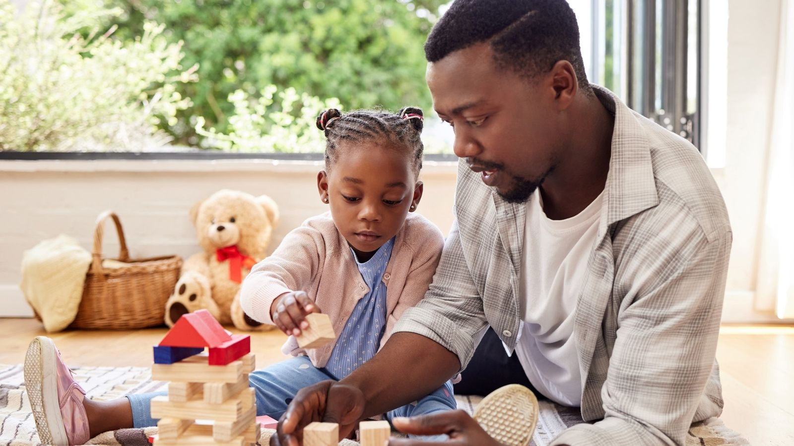 a child plays with toy blocks at home