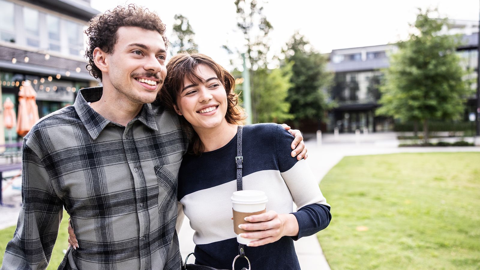 young-couple-walking-outside-drinking-coffee