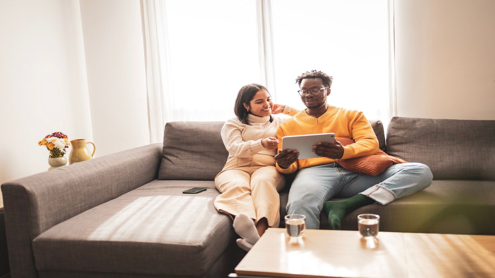 Couple relaxing on a sofa having a conversation