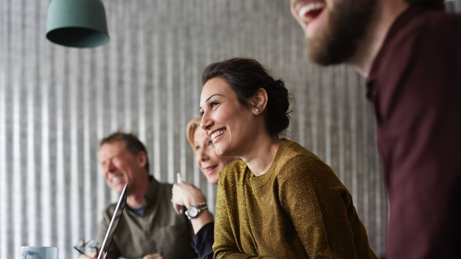 Woman in business meeting smiling.