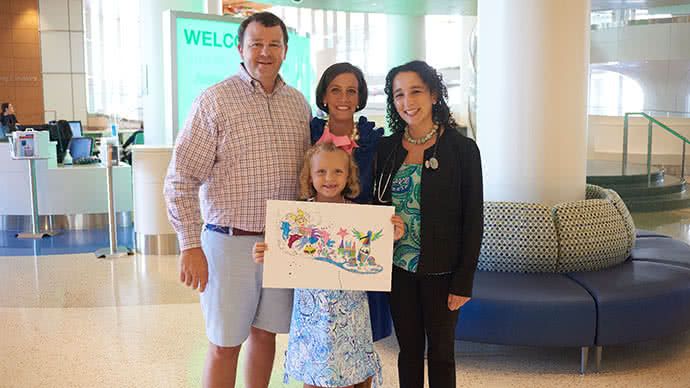 Gilger Family standing next to their researcher, Dr. Yael Mossé