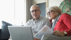 Older couple researching how much it costs to retire