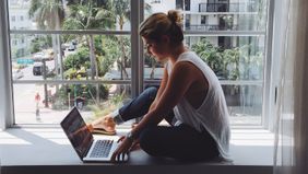 Woman working in a window planning her retirement savings