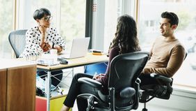Advisor discussing strength of couples financial plan in a storm