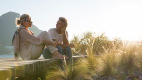 couple relaxing on boardwalk