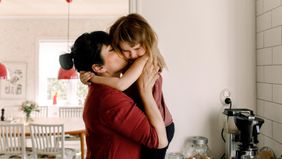 Mom and daughter embracing while quarantining