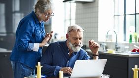 Couple using a laptop to research how does an annuity work?