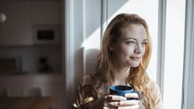 Woman drinking coffee wondering how long does long-term disability last.