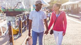 senior couple holding hands discussing what is a good monthly income