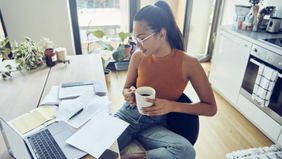 woman at home desk filing taxes early