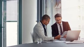 Two men discussing how to find the right financial advisor
