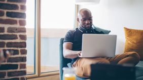 Man on laptop looking at his investment portfoilo