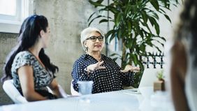 Woman building a multifaceted plan for retirement with her team of advisors.