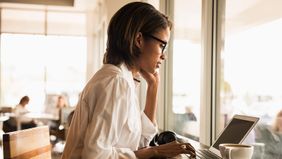Woman on laptop improving her digital security