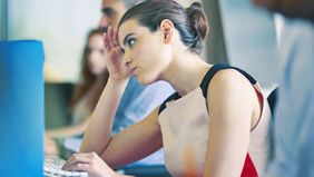 Stressed woman experiencing burn out at work