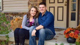 Couple who paid off $50k in debt sitting on their porch