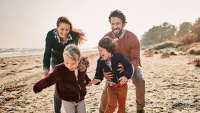 Family on beach after keeping their financial resolutions