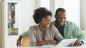 Couple on tablet to get out of debt in 2018