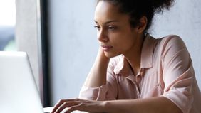 Woman researching short term disability insurance on her computer