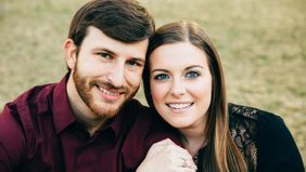 Couple who paid off $40k in student loan debt sitting outside